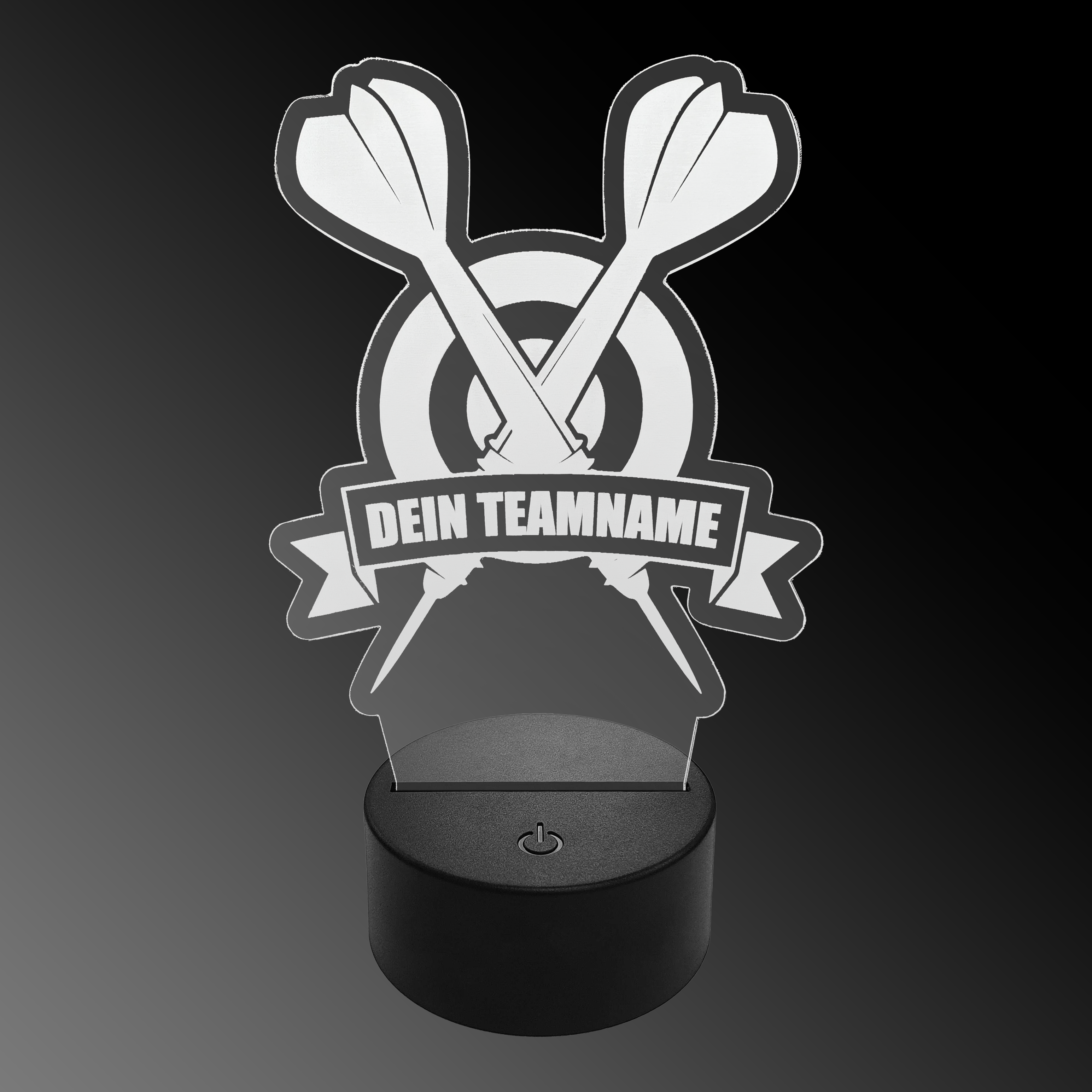 Lampe à fléchettes LED en plexiglas avec texte personnalisé Das Bild zeigt eine LED-Lampe aus Plexiglas in Form von zwei gekreuzten Dartpfeilen vor einer Zielscheibe. Auf einem Banner steht der Text "DEIN TEAMNAME".