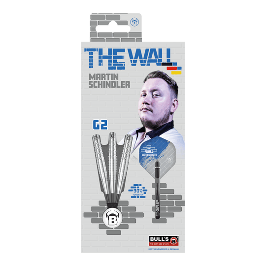 Fléchettes en acier Bulls Martin Schindler Original Generation 2 Die Verpackung zeigt die "Bulls Martin Schindler Original Generation 2 Steeldarts" mit dem Bild von Martin Schindler. Auf der Vorderseite sind drei Darts und die Aufschrift "THE WALL" sowie "90% Tungsten" abgebildet.