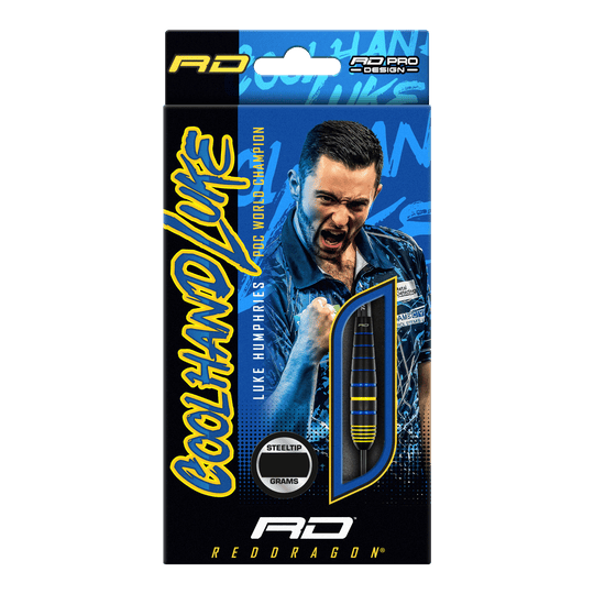 Fléchettes Red Dragon Luke Humphries, champion du monde en laiton et acier Auf der Verpackung sind die "Red Dragon Luke Humphries World Champion Brass Steeldarts" abgebildet. Im Hintergrund ist ein jubelnder Spieler zu sehen, daneben ist ein Dartpfeil durch ein Sichtfenster sichtbar.