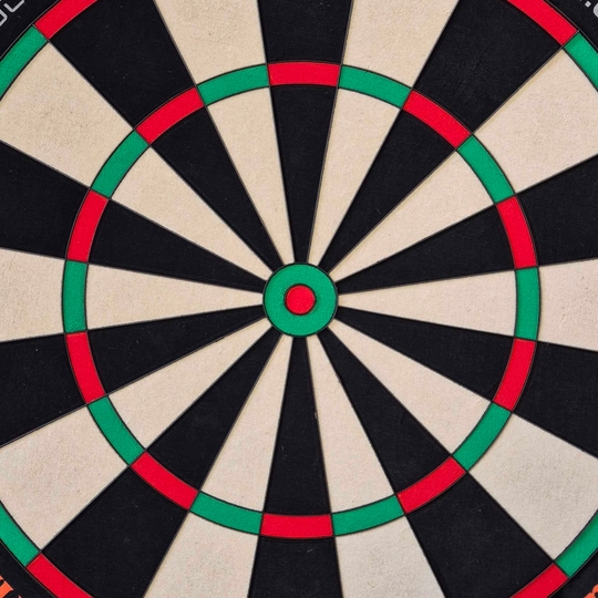 Cible de fléchettes en acier Unicorn Eclipse Ultra 2.0 Das Bild zeigt eine Nahaufnahme einer Dartscheibe mit klaren Farbfeldern in Schwarz, Weiß, Rot und Grün. Es handelt sich um das Produkt "Unicorn Eclipse Ultra 2.0 Steeldartboard".
